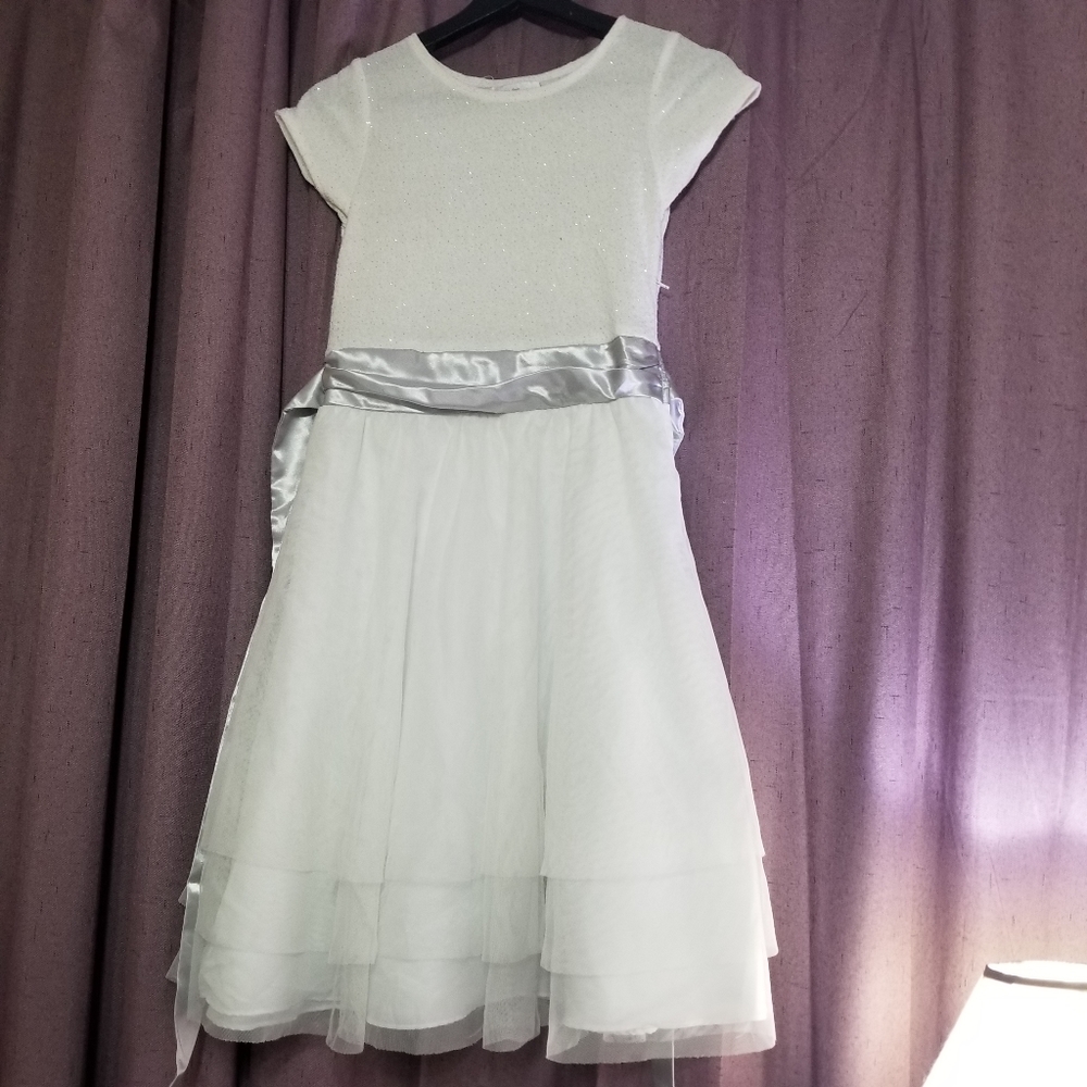An all white dress with Cilver touches